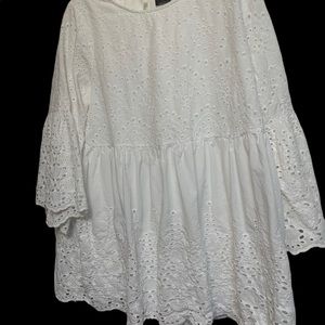 White eyelet top with a scoop neck and three-quarter sleeves. NWOT.